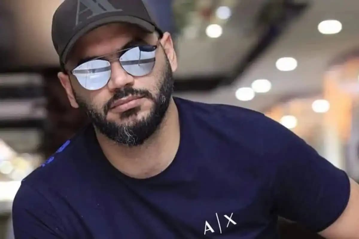 Portrait of Hassan Hayek, a middle-aged man with dark hair and a thoughtful expression.