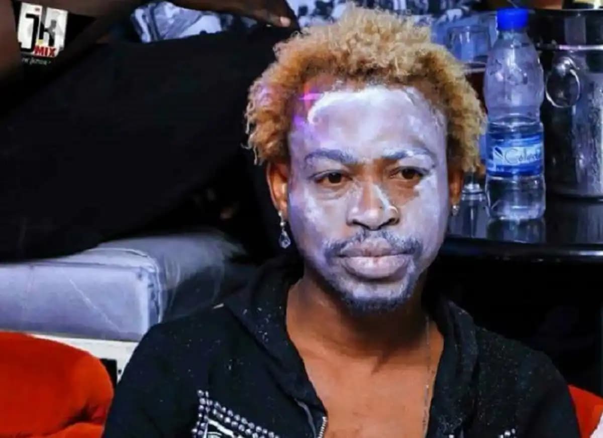 A playful skeleton character with a big smile, wearing a colorful hat and bowtie, standing in a cheerful pose.