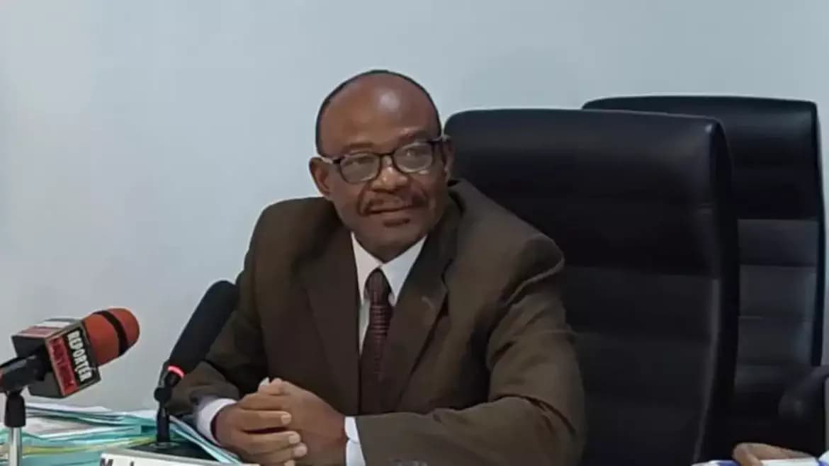 Jean-Baptiste Elias speaking at a podium during a press conference on tax clearance for elections in Benin.