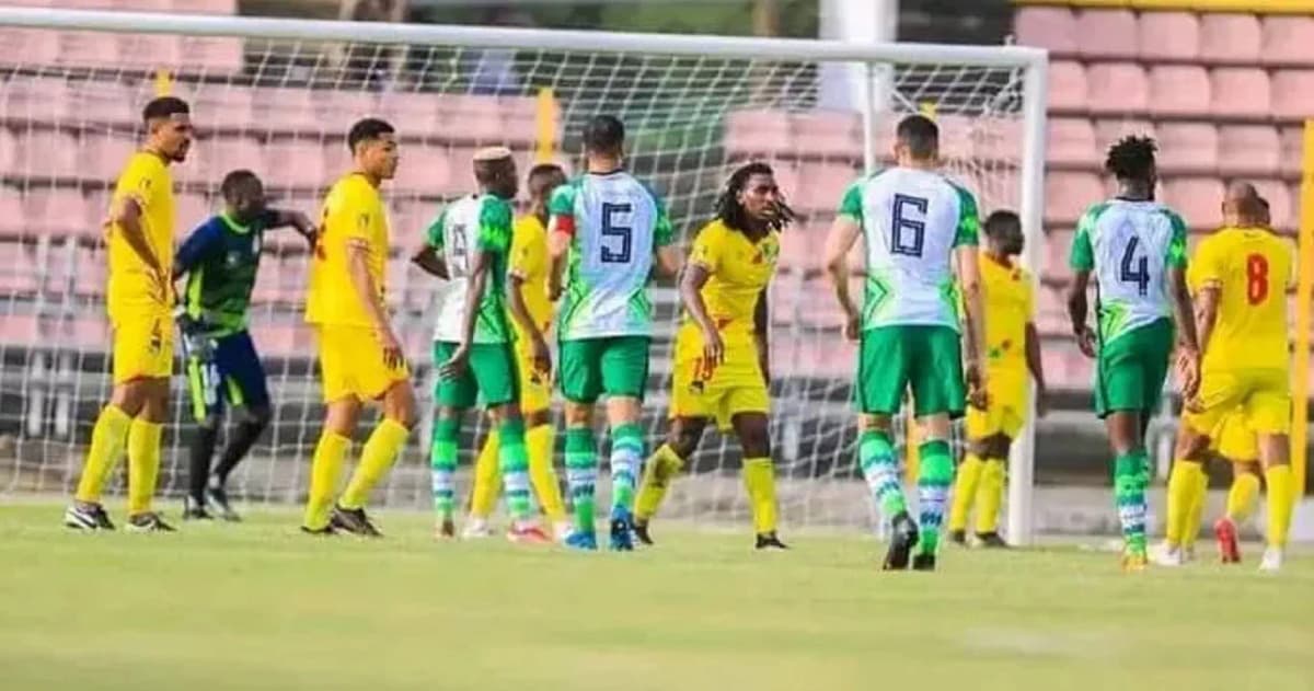 Nigerian and Beninese players competing on the field during a World Cup qualifier match.