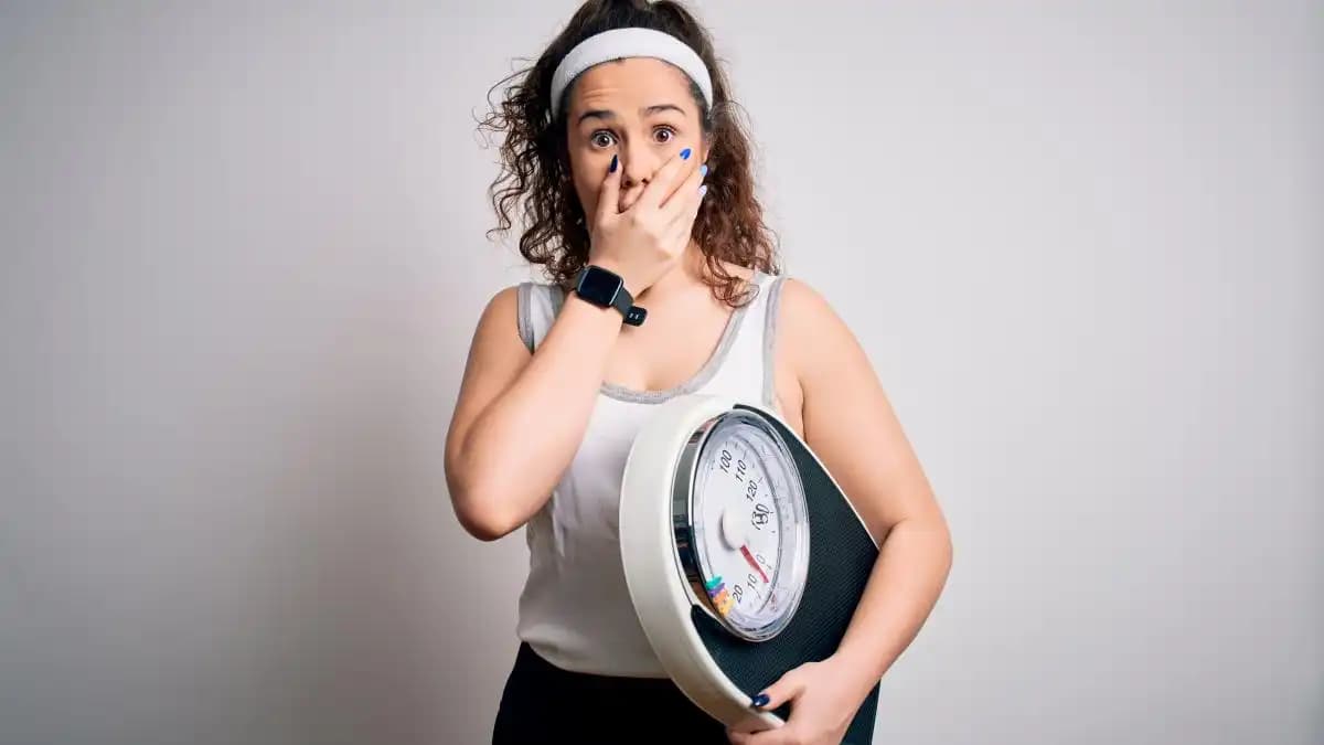 Personne pesant des aliments sains pour un régime équilibré et efficace.