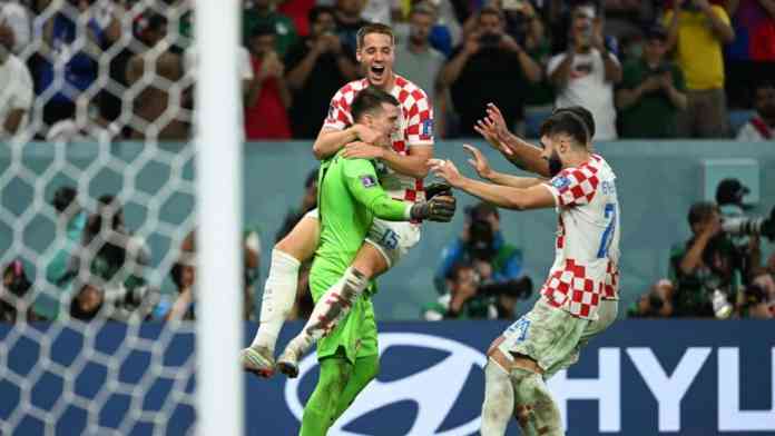 Dominik Livaković et les joueurs de la Croatie célèbrent la qualification pour les huitièmes de finale de la Coupe du monde 2022
