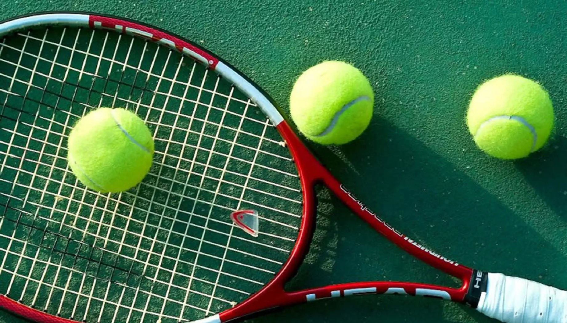 Tennis racket and ball on a surface, representing the sport for the upcoming championship.